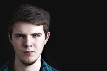 Portrait of a serious young man looking to camera