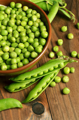 Fresh green pea pod on wooden background