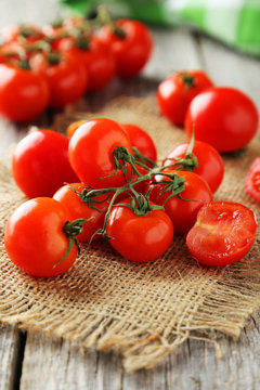 Fresh cherry tomatoes on grey wooden background