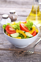 Fresh vegetable salad on grey wooden background