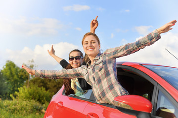 Girls in a red car.