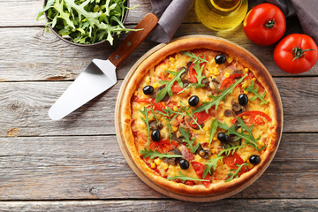 Fresh tasty pizza on grey wooden background