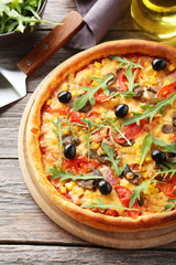 Fresh tasty pizza on grey wooden background