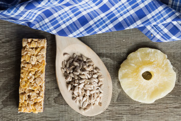 Seeds in Wooden Spoon Spread on Wood Background with Table Cloth