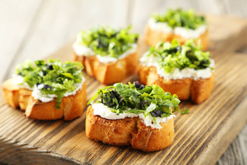 Tasty fresh bruschetta on cutting board on grey wooden backgroun