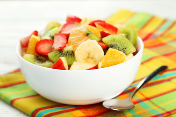 Fresh fruit salad on white wooden background