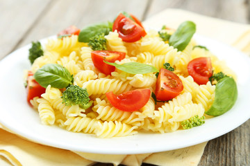 Delicious pasta on plate on grey wooden background