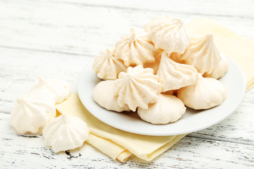 French meringue cookies on white wooden background