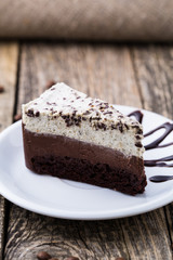 Chocolate dessert with coffee cup and coffee beans on wooden bac