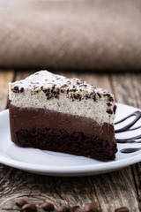 Chocolate dessert with coffee cup and coffee beans on wooden bac