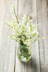 Lily of the Valley on grey wooden background