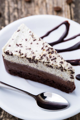 Chocolate dessert with coffee cup and coffee beans on wooden bac