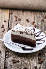 Chocolate dessert with coffee cup and coffee beans on wooden bac