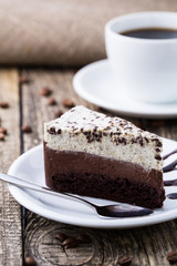 Chocolate dessert with coffee cup and coffee beans on wooden bac