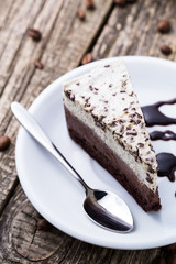 Chocolate dessert with coffee cup and coffee beans on wooden bac