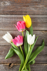 Beautiful tulips on grey wooden background