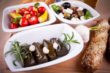 Vine leaves stuffed with peppers and Mediterranean antipasti