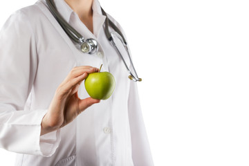 Female doctor's hand holding green apple isolated on white 