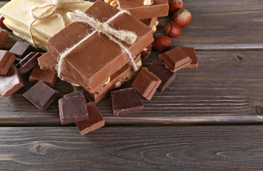 Set of chocolate with hazelnut on wooden table, closeup