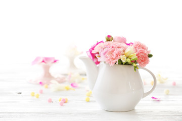 Beautiful spring flowers in teapot