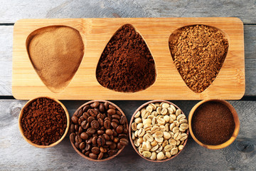 Various of coffee in small dishes on wooden table, top view