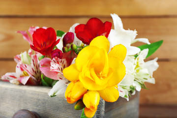 Beautiful spring flowers on wooden background