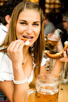 Girl drinking beer at Oktoberfest