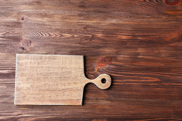 Cutting board on wooden background