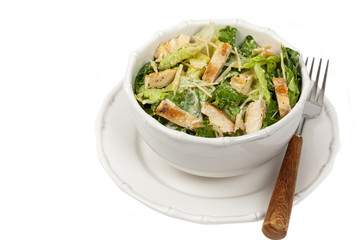 Chicken Caesar Salad on white background. Selective focus.