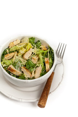 Chicken Caesar Salad on white background. Selective focus.