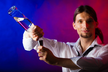 Young man bartender preparing alcohol drink