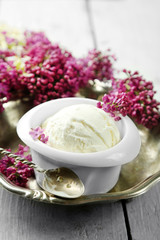 Beautiful composition with tasty ice cream and lilac flowers
