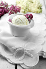 Beautiful composition with tasty ice cream and lilac flowers
