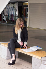 Young business woman sitting and deal with documents