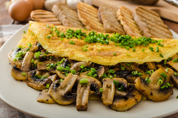 Rustic omelette with mushrooms on chives