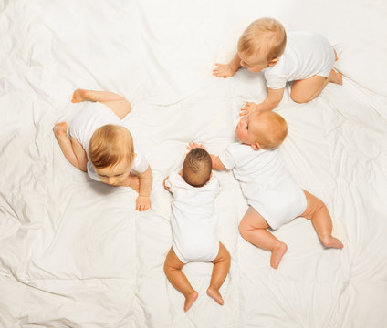View from top of four sweet babies backs crawling