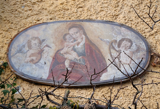 Virgin Mary with baby Jesus painting on house facade in Hallstatt, Austria.