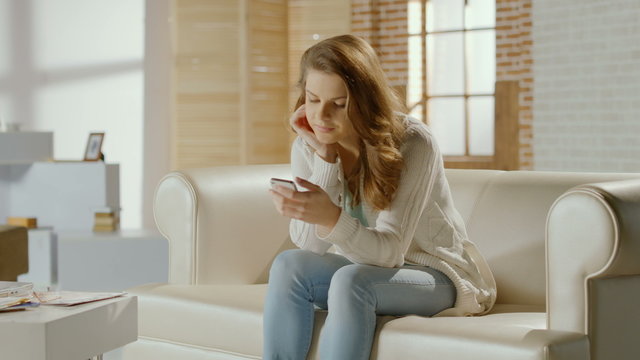 Young woman enjoying communication with friend in chat on phone
