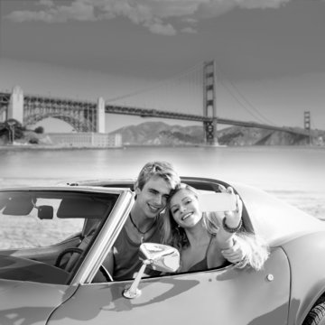 selfie of young couple convertible car Golden Gate