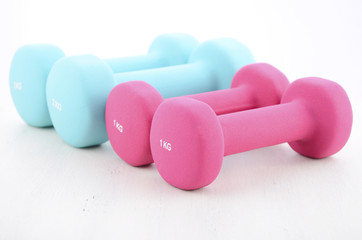 Health and fitness concept with feminine dumbbells