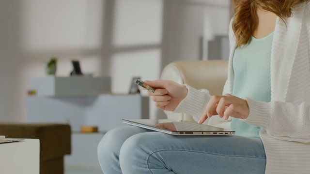 Female inserting card number, online banking service on tablet