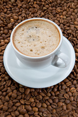 Coffee cup and coffee beans. Close up