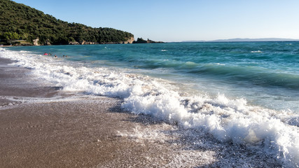 Fototapeta na wymiar White sand beach and blue sky. Beach background in Greece