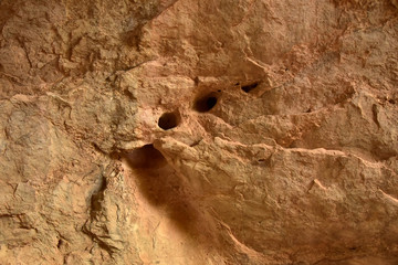 The walls of the cave with a hole in the wall