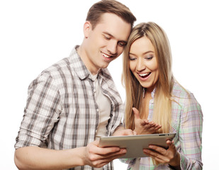 happy young couple holding tablet pc computer 