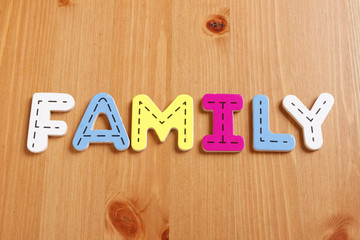 FAMILY, spell by woody puzzle letters with woody background