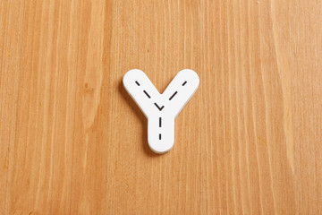 Y, spell by woody puzzle letters with woody background