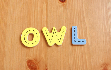 OR, spell by woody puzzle letters with woody background