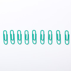 Image of green paper clips isolated on white background