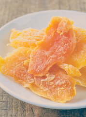 Piece of Dehydrated mango on white ceramic dish
